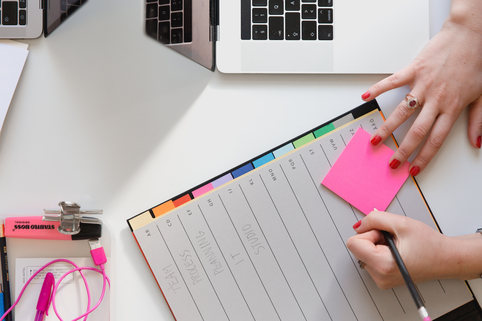 day planner with pink post-it note